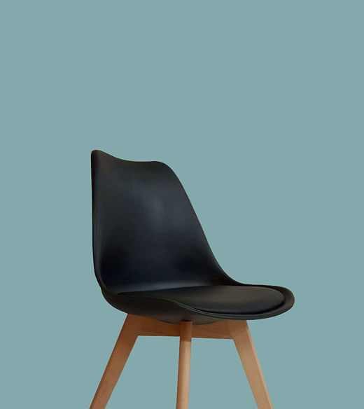 Black chair on a teal background